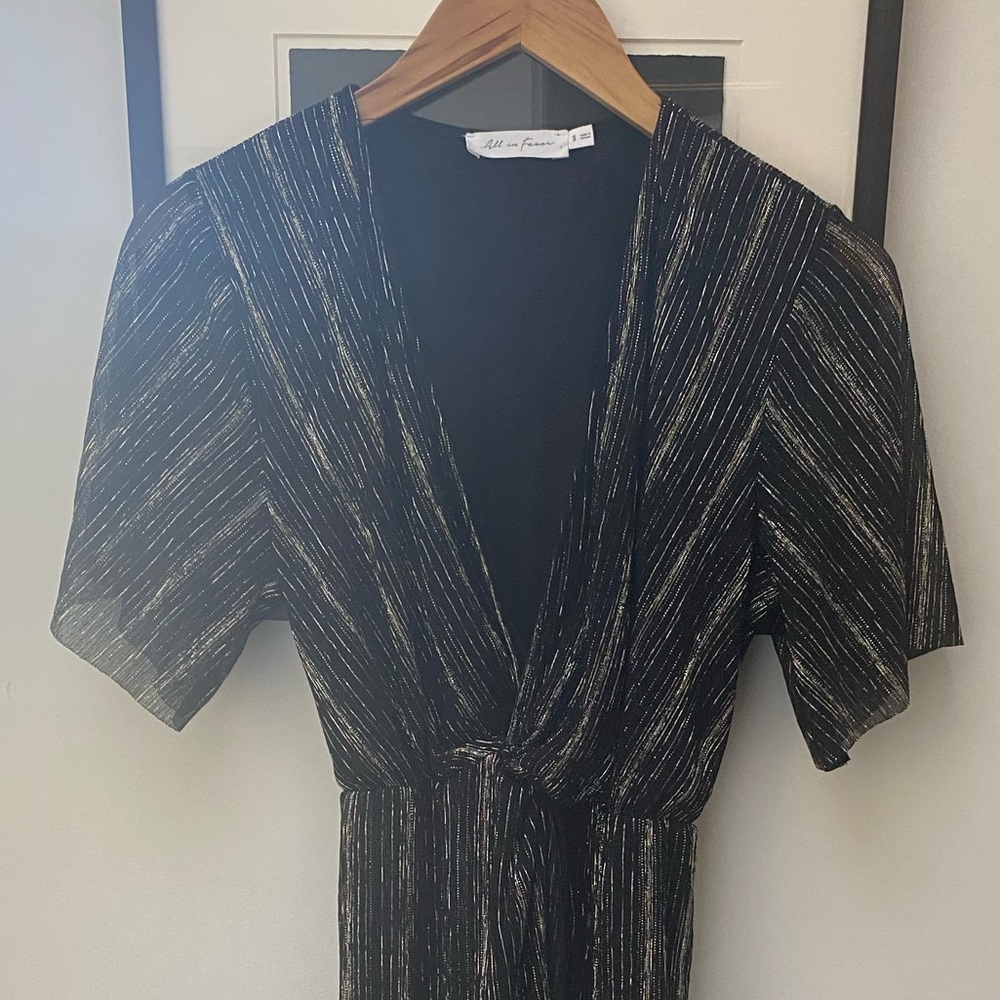 Fun for holiday parties! Black with gold. Mid- length. Size small. Elastic waist